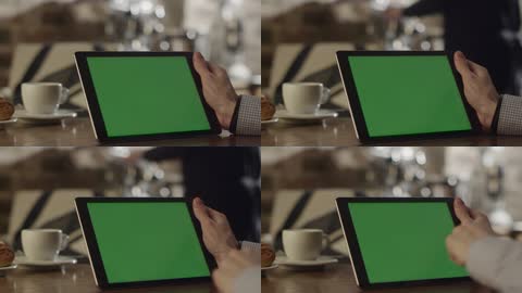 实拍在咖啡厅男人操作绿屏平板电脑