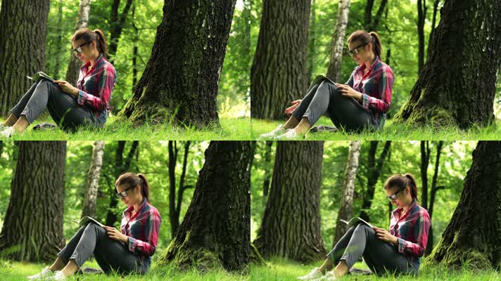 女孩坐在森林草地上看书