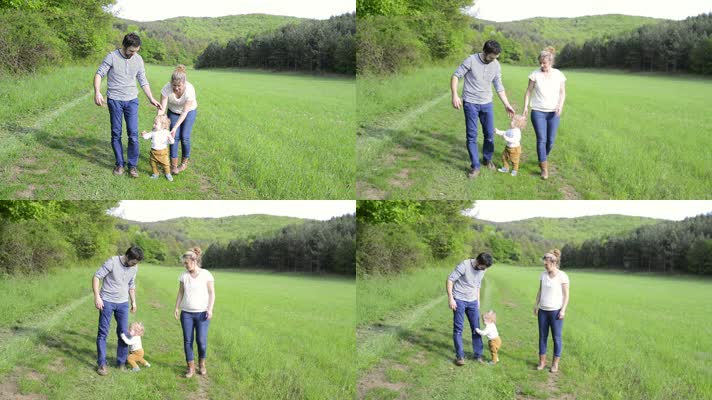 父母带着孩子在草地上练习走路实拍视频