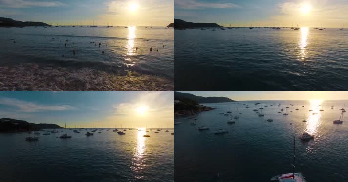 海岸海水视频夕阳下大海里游泳的游客帆船