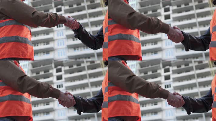 建筑工地上合作握手