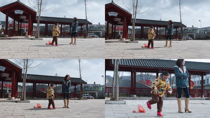 春节过年乡村母子玩摔炮的小男孩