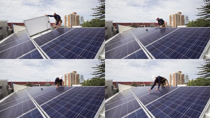 太阳能技术人员在屋顶上安装太阳能