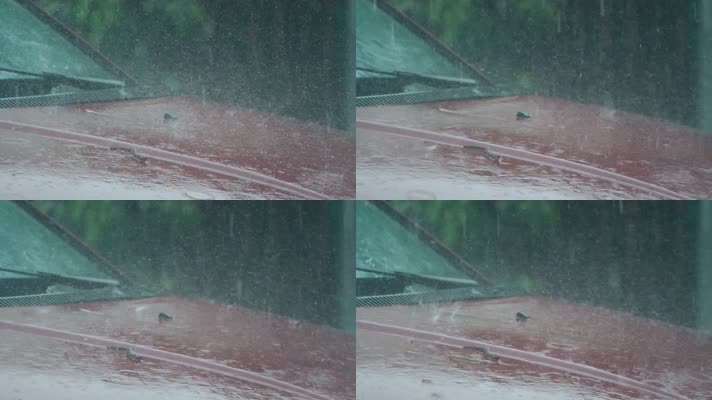 暴雨天气雨水落在汽车车前盖