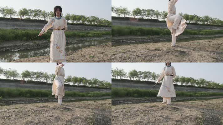 汉服少女在河边沙滩上练习舞刀