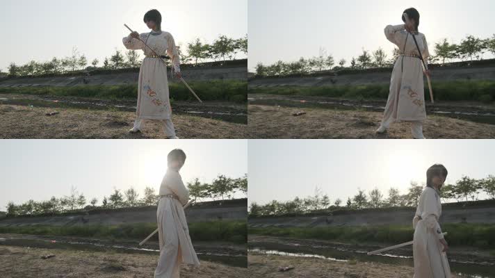 汉服少女在河边沙滩上练习舞刀