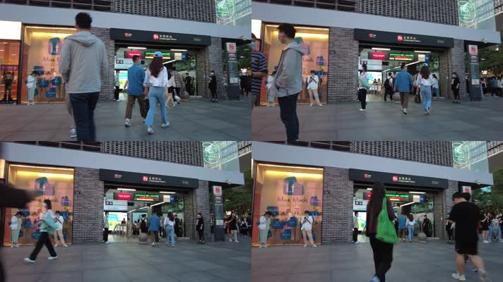 杭州地铁站前散步的行人