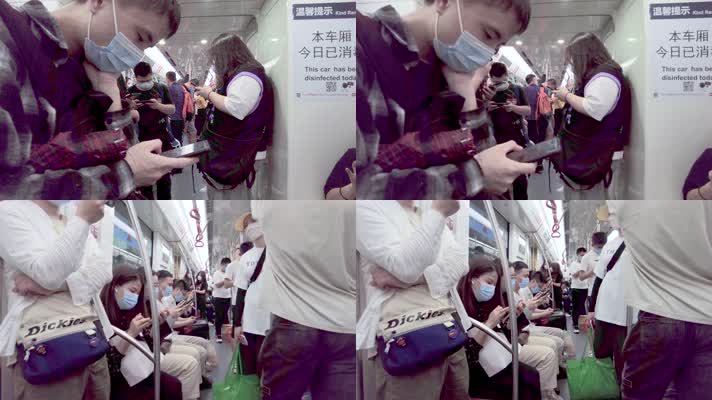 地铁玩手机的乘客