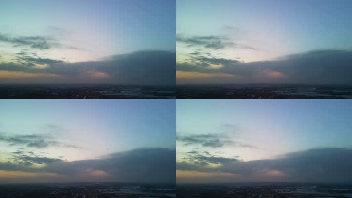 4K航拍-夕阳中飞机下降高度掠过天空