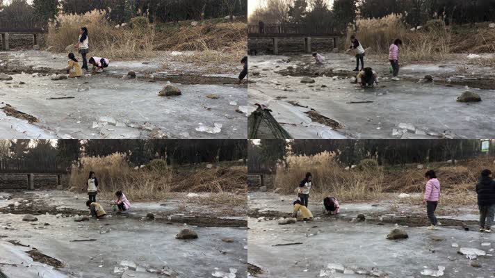 冬天男女儿童在冰冻小河上面玩耍