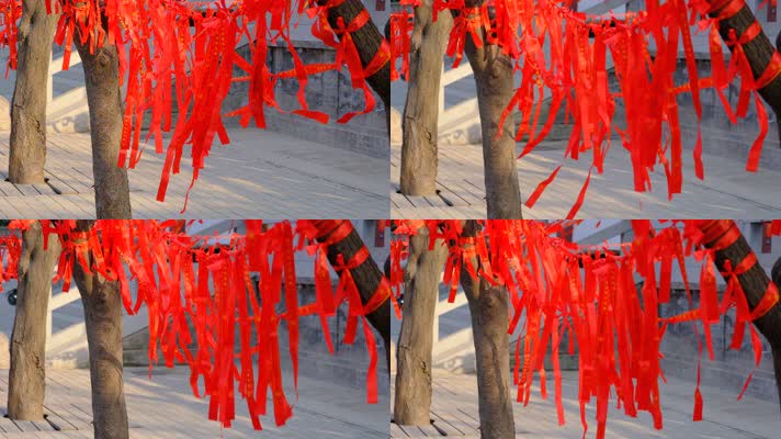 寺庙里在微风中飘动的红色祈福带