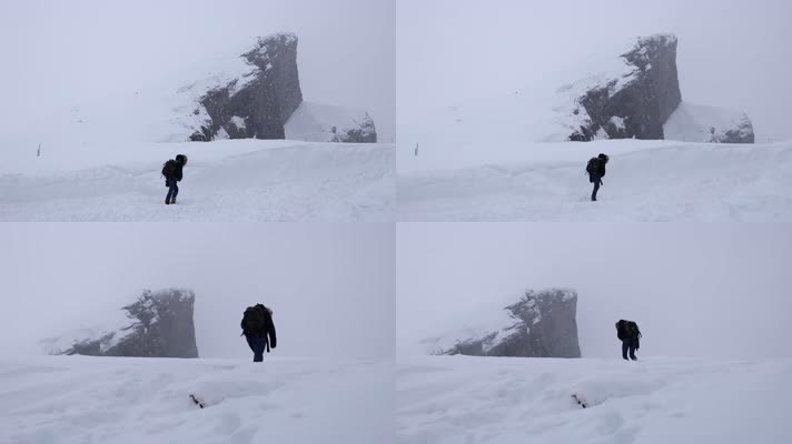 登山者风雪中孤独行走徒步攀登