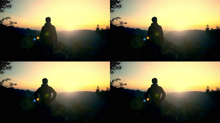 男人站在山顶看日出