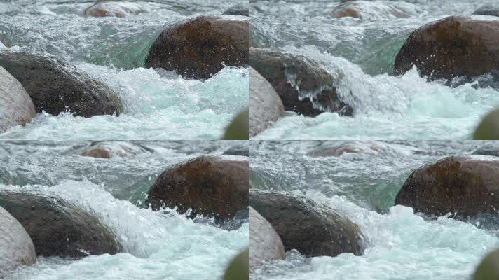 河里打到石头上溅起的水珠激流清澈